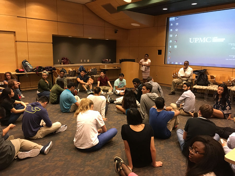 Group of Students Sitting on Floor Learning in Group Discussion